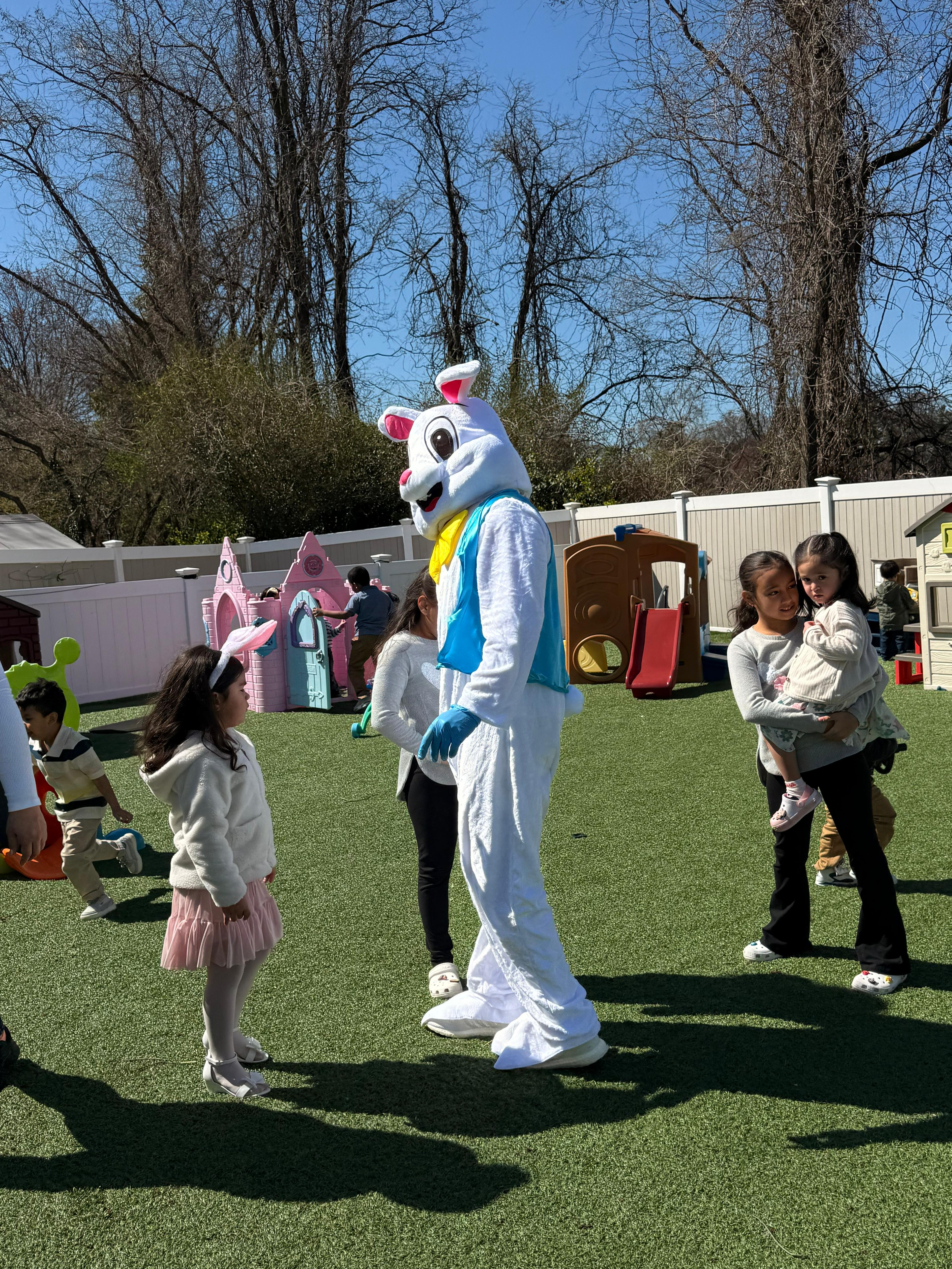 Easter Bunny visiting children on the playground