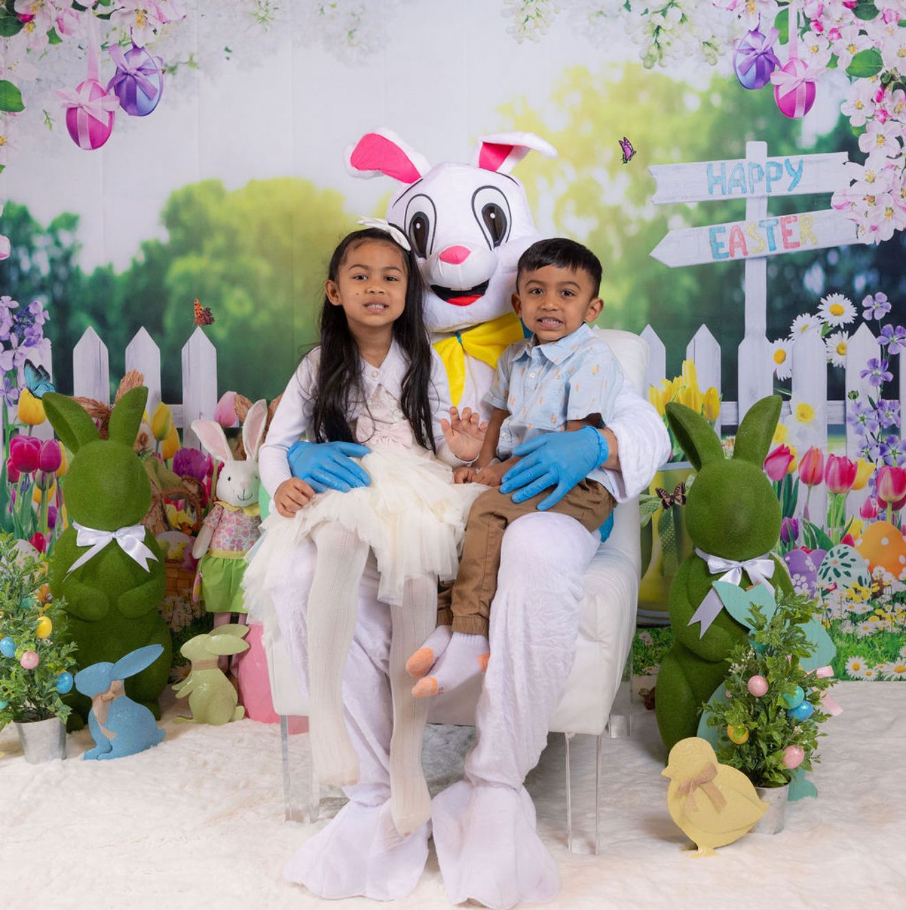 Children posing with the Easter Bunny for holiday photos
