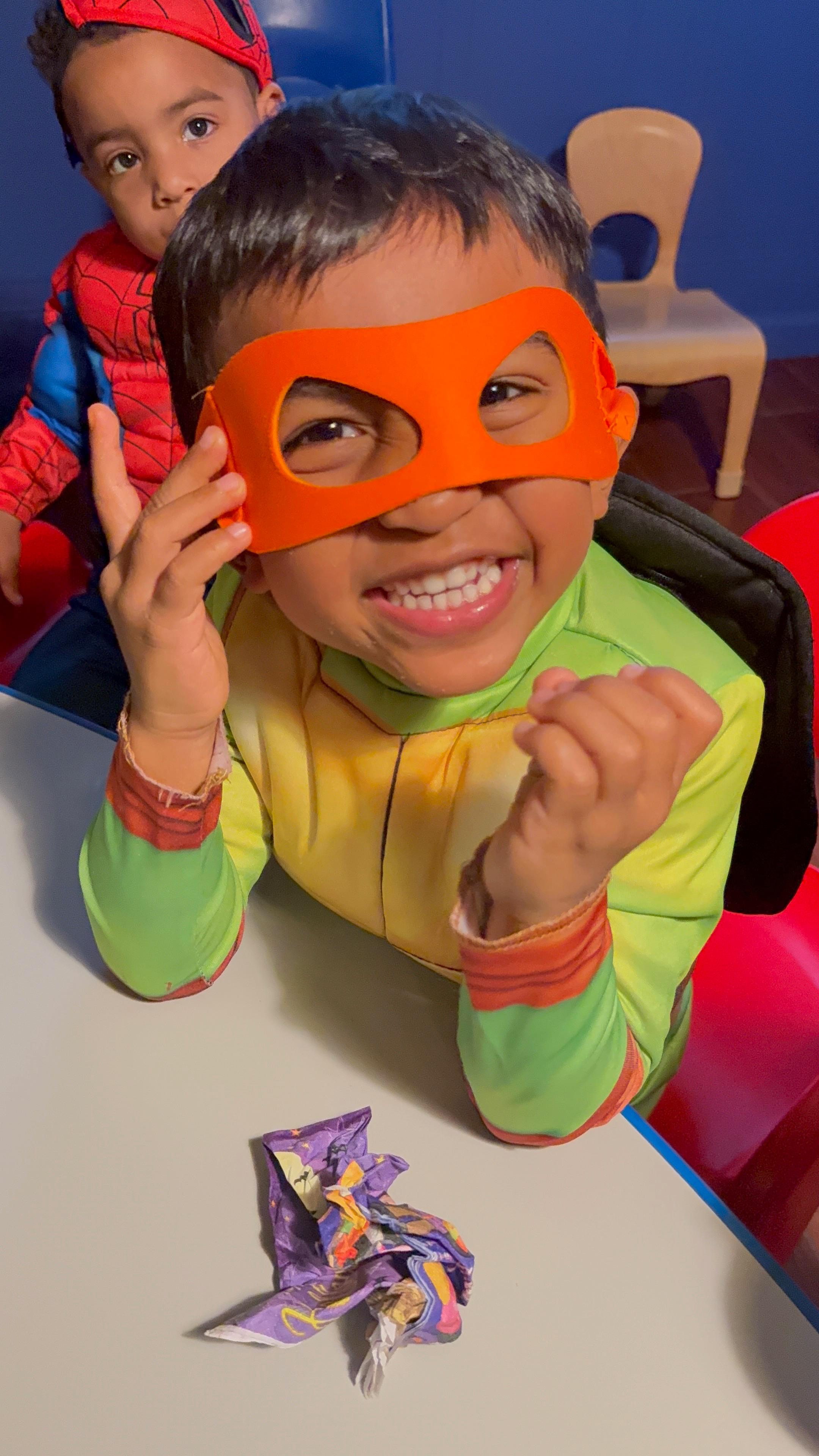 Children in Halloween costumes having fun at the daycare