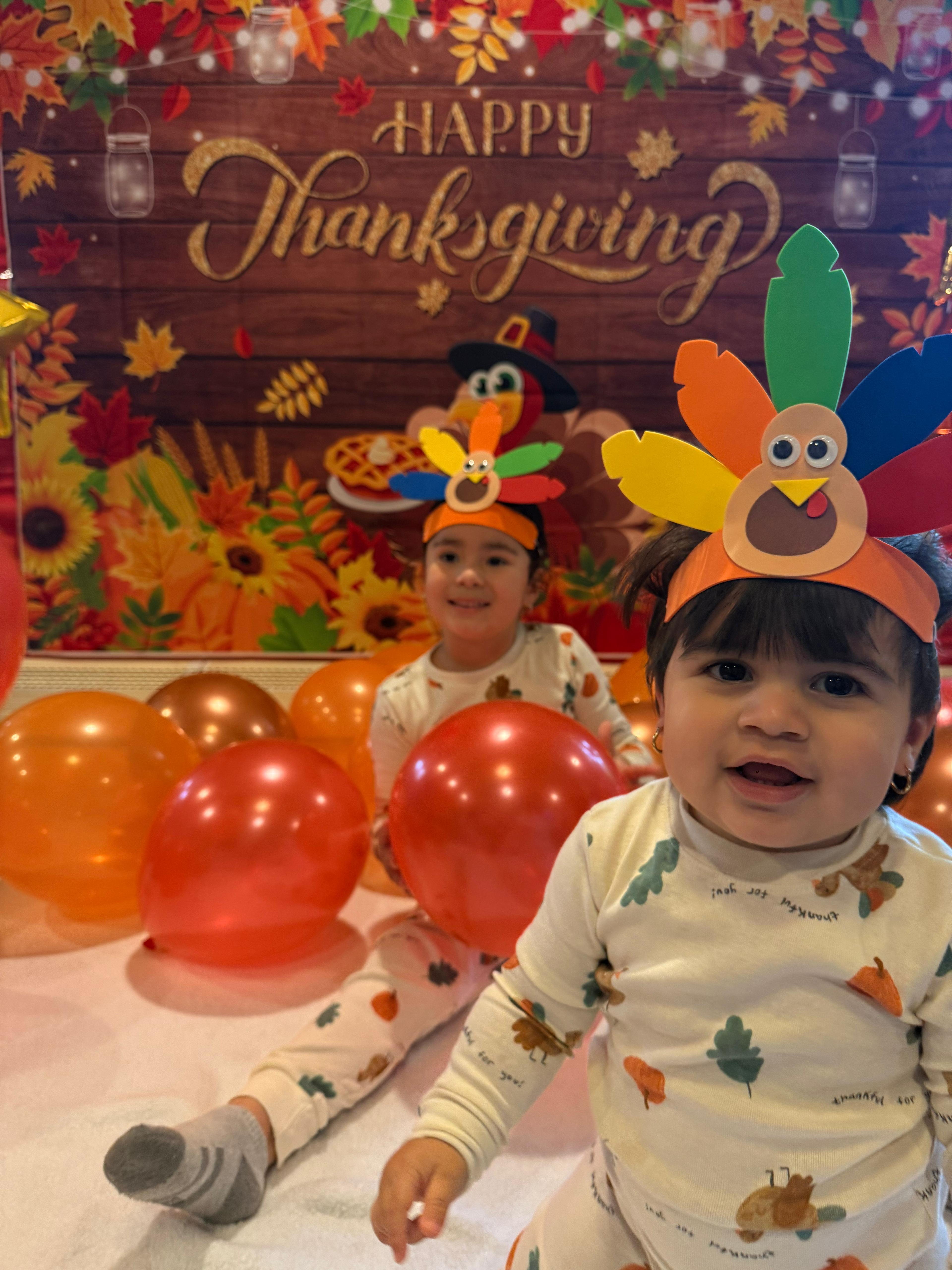 Kids celebrating Thanksgiving with turkey headbands and festive decorations
