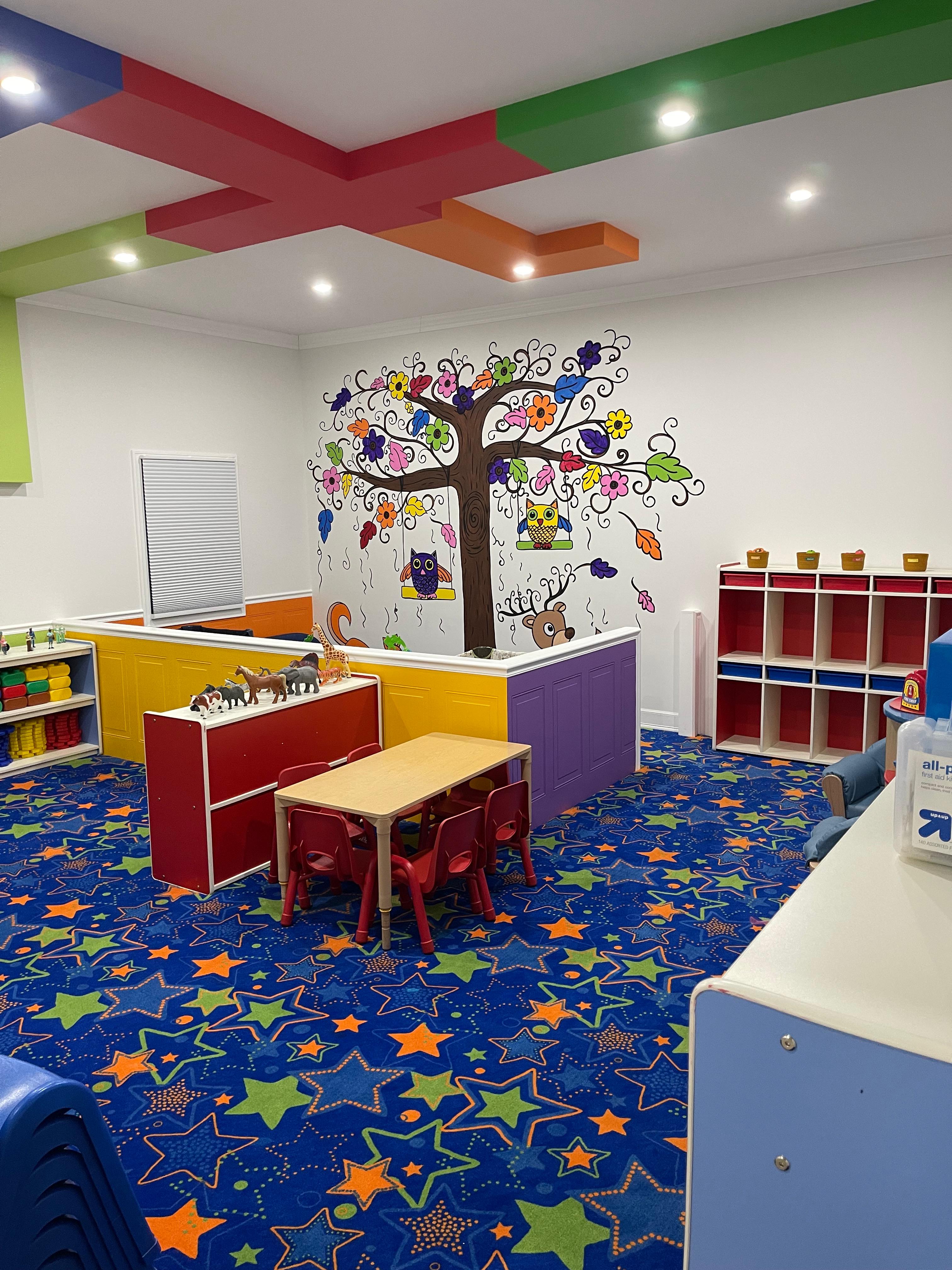 Bright learning space with owl mural and activity tables